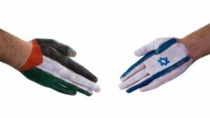 Hands reaching out to each other, one painted as the Israeli flag, the other as the Palestinian flag