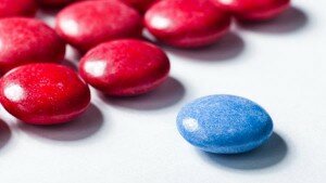 M&M candies, most red, one blue