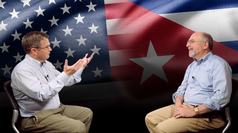 Bruce Jentleson and Peter Feaver with a backdrop of the U.S. and Cuba flags