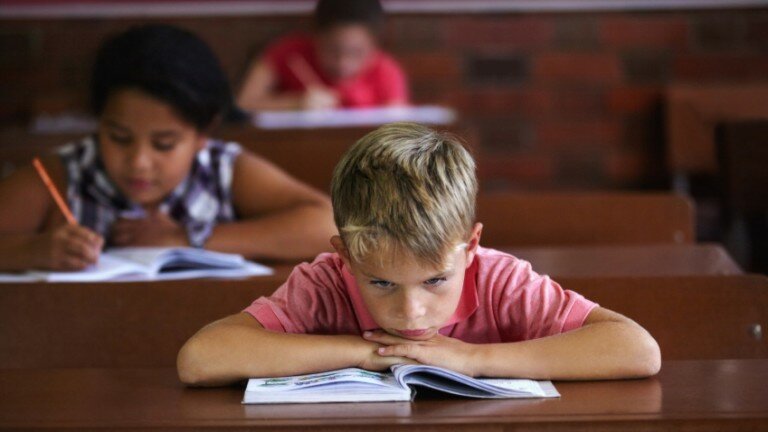 Student looking frustrated in a classroom