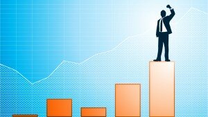 Illustration of a businessman with raised fist standing on top of a bar graph