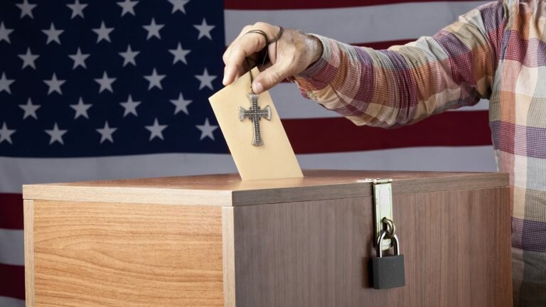 Man putting a vote in a ballot box is also holding a cross