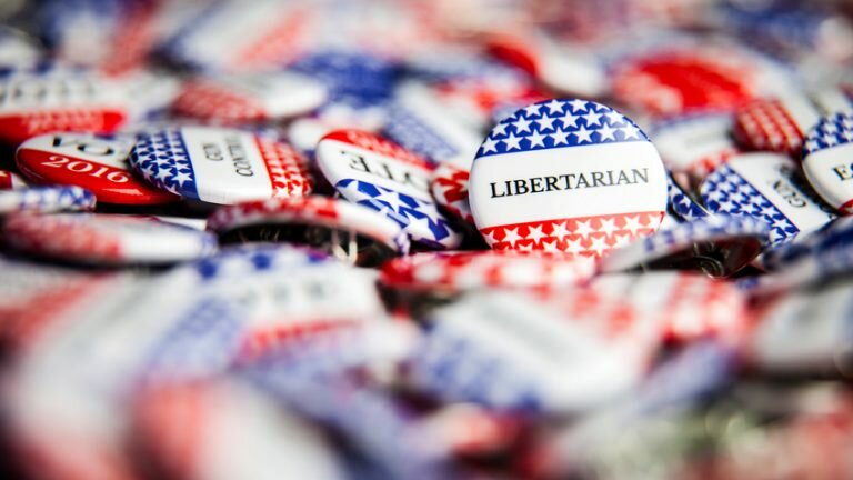 Pile of campaign buttons; the most prominent reading "Libertarian"