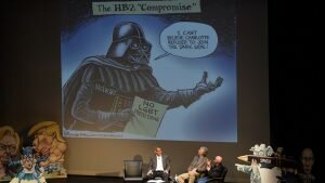 3 men are on a stage; on the screen behind them a cartoon is projected. The cartoon is titled "The HB2 'Compromise'" and shows Darth Vader (labeled "McCrory") holding a piece of paper reading "No LGBT Protections" and saying "I can't believe Charlotte refused to join the dark side!"